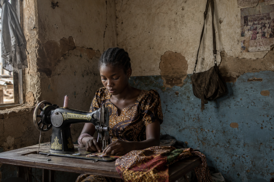 A young woman at a sewing machine in the Lives Transformed skills center in Nigeria.